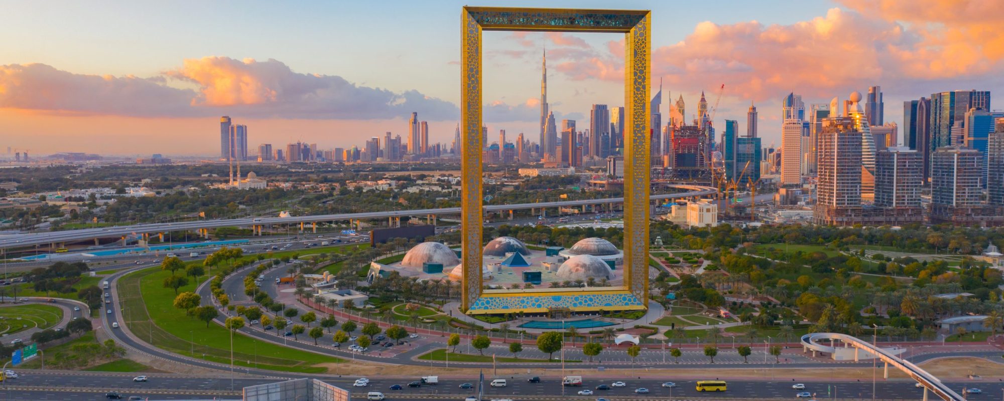 Aerial view of Dubai Frame, Downtown skyline, United Arab Emirates or UAE. Financial district and business area in smart urban city. Skyscraper and high-rise buildings at sunset.