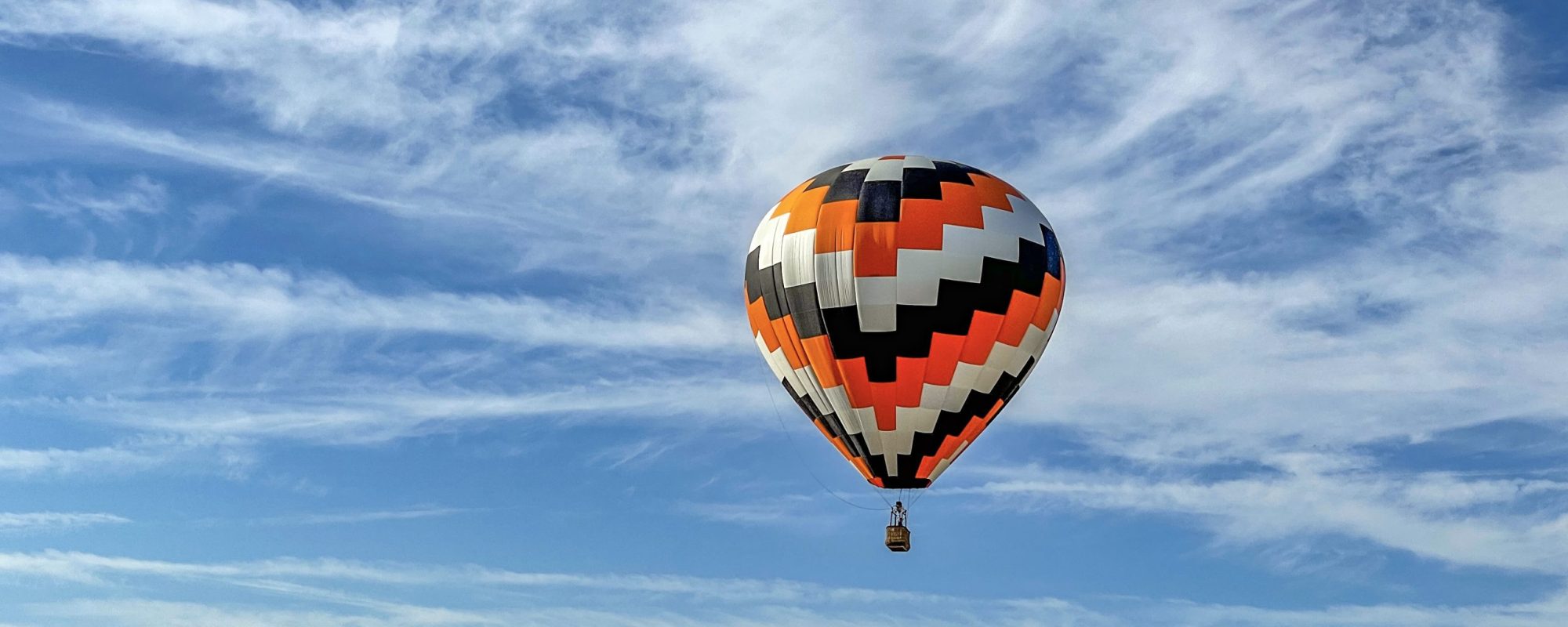 A colorful air balloon flying in the sk