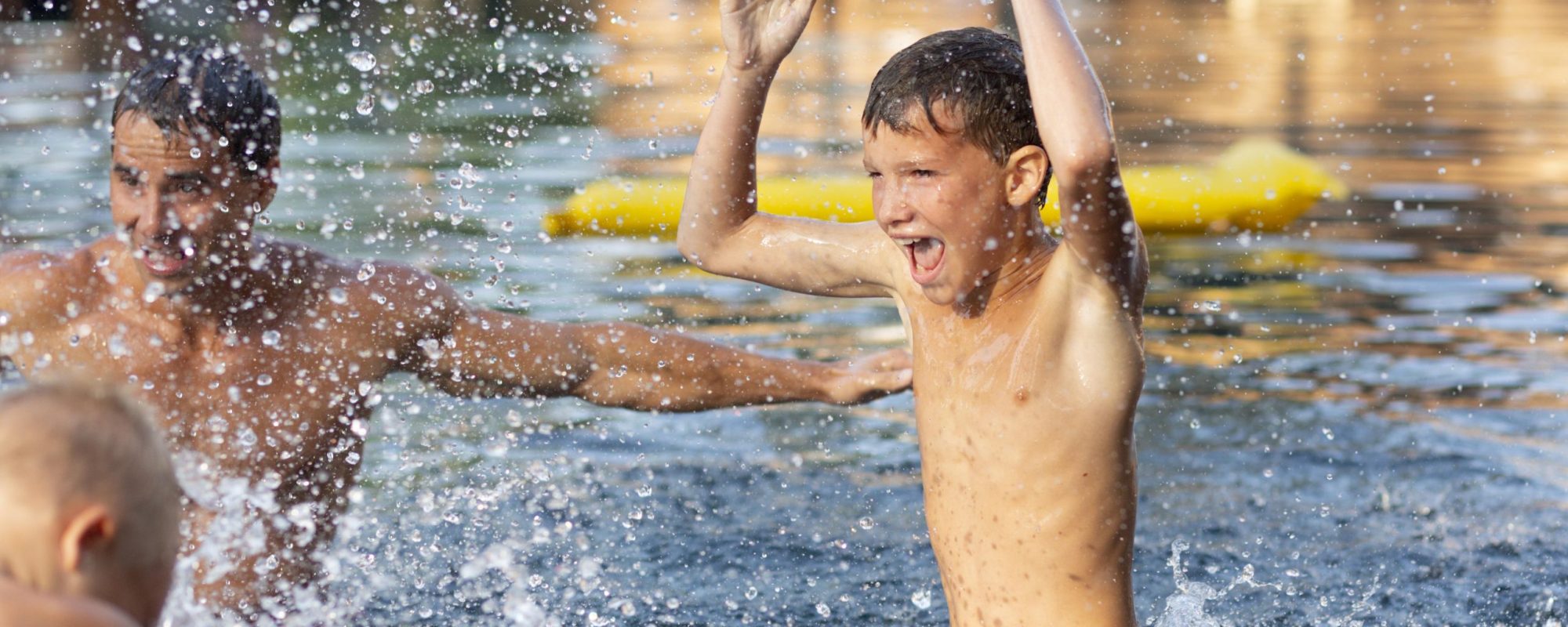 father-enjoying-day-with-his-kids-swimming-pool