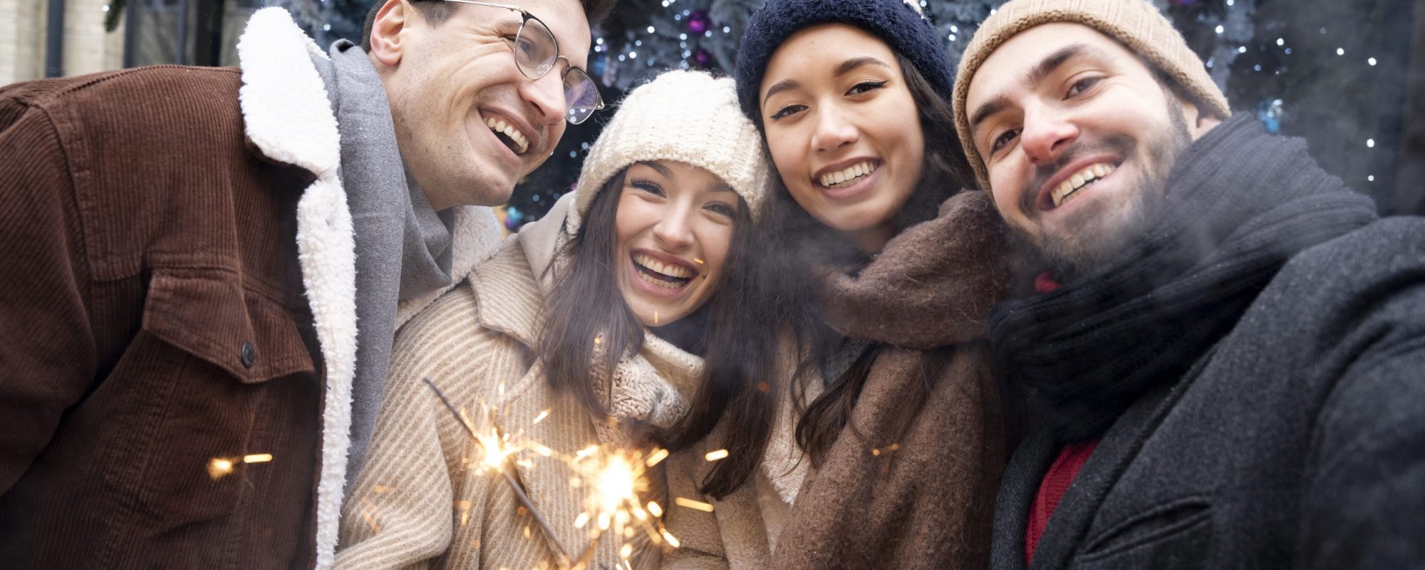 group-friends-holding-sparklers-together